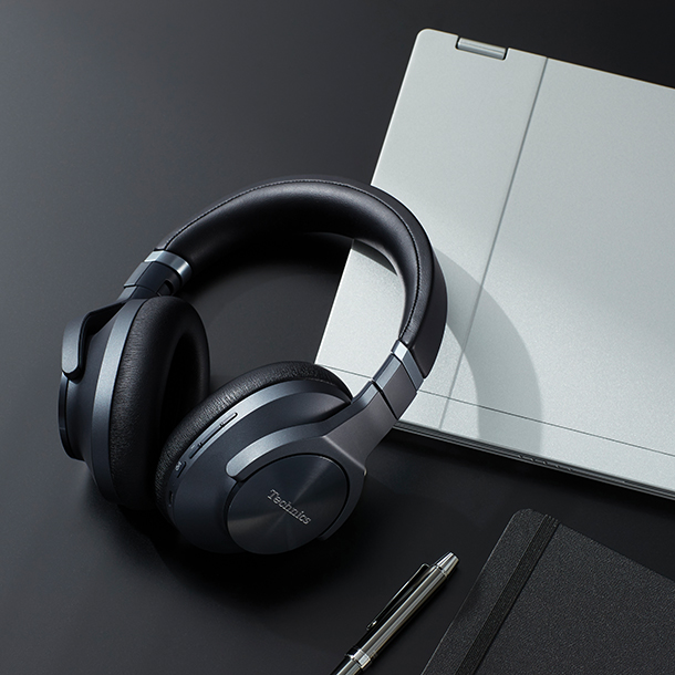 Technics EAH-A800 noise-canceling headphones on desk with laptop